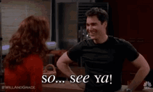 a man in a black shirt is standing next to a woman in a red shirt and saying `` so ... see ya ! ''