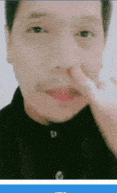 a close up of a person 's face with their finger in their nose .