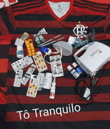 a black and red adidas shirt is covered in pills and bottles