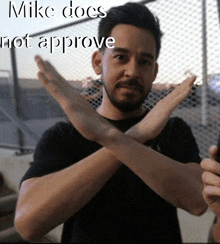 a man crosses his arms with the words mike does not approve behind him