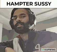 a man wearing headphones says hampter sussy on the bottom