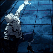 a person with a tattoo on their chest is laying on the ground
