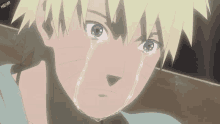 a close up of a naruto crying with tears running down his face .