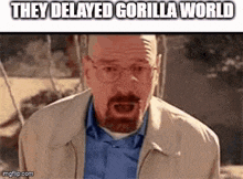 a man with glasses and a beard is making a funny face while wearing a jacket .