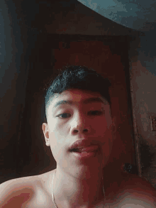 a young man without a shirt is laying down