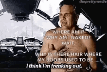 a shirtless man is talking to another shirtless man in a car while holding his chest .