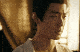 a close up of a man 's face with a white shirt on
