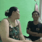 a man and a woman are sitting next to each other in a living room .