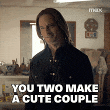 a man is standing in a room and says you two make a cute couple