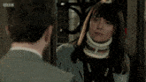 a woman wearing a neck brace talks to a man with the words " and in the presence of my police federation rep "