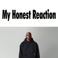 a man in a black hoodie stands in front of a white background with the words my honest reaction