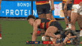 a rugby game is being played in front of a bondi protein sign