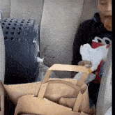 a person is sitting in the back seat of a car holding a bag and a napkin
