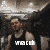 a man in a tank top with the words wya cuh written on his chest