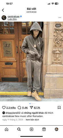 a phone screen shows a picture of centralcee standing in front of a building