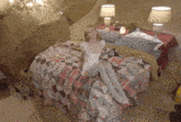 a woman is sitting on a bed with a blanket that says ' a ' on it