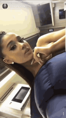 ariana grande is taking a selfie with a blue pillow