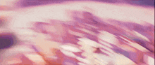 a close up of a purple and pink background with a blurred image of a person 's face .