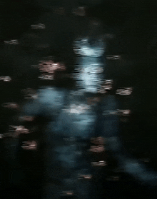 a blurry picture of a person 's face in a dark room