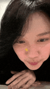 a close up of a woman 's face with a star on her nose