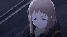 a girl with brown hair and blue eyes is looking down