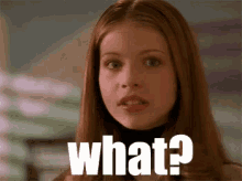 a woman with long hair is looking at the camera and says what ?
