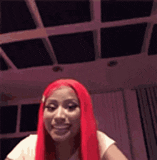 a woman with red hair is making a funny face in a room .