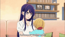 a woman is holding a child and says " you hungry "