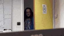 a man standing in front of a door with a sign on it that says ' no smoking '