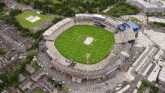 an aerial view of a cricket stadium with the letters u on the field