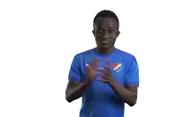 a man wearing a blue shirt with a puma logo on it is clapping his hands
