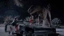 a t-rex is standing on top of a car with a license plate that says t-rex on it