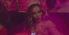 a woman is sitting on a couch in a room with smoke coming out of her hair .