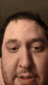 a man with a beard is making a funny face with his mouth open .
