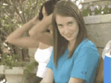 a girl wearing a blue shirt with the letter c on it