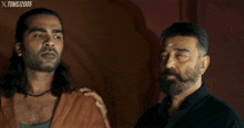 two men are standing next to each other with xtoms 2005 written on the bottom right