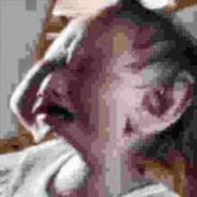 a close up of a person 's face with their mouth open and their eyes closed .