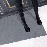 a pair of black boots with a diamond design on the heel