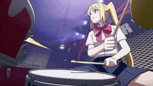 a girl is playing drums in front of a sign that says r