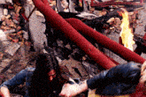 a woman is standing in front of a burning building