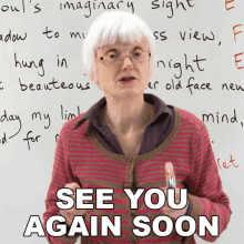 an elderly woman stands in front of a whiteboard with the words see you again soon written on it