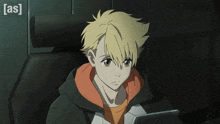 a boy with yellow hair is sitting in front of a screen that says as