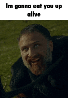 a man with a beard is smiling and says `` im gonna eat you up alive '' in a meme .