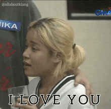 a woman holding a glass with the words " i love you " written on it
