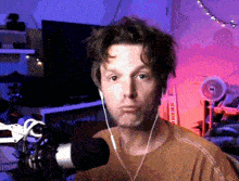 a man wearing headphones stands in front of a microphone in a room with a sign that says run away