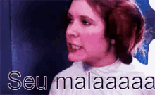 a close up of a woman 's face with the words seu malaaaa written below her
