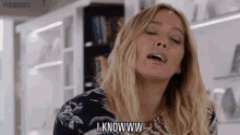 a woman with blonde hair is making a funny face and saying `` i knowww '' .