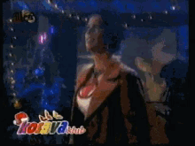 a woman in a red jacket is dancing in front of a sign that says " kool club "