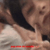 a close up of a person 's face with the words pop eres de kamila written in red
