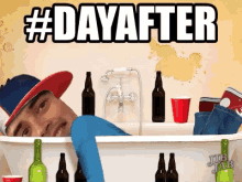 a man is laying in a bathtub surrounded by beer bottles and red cups with the words #dayafter above him